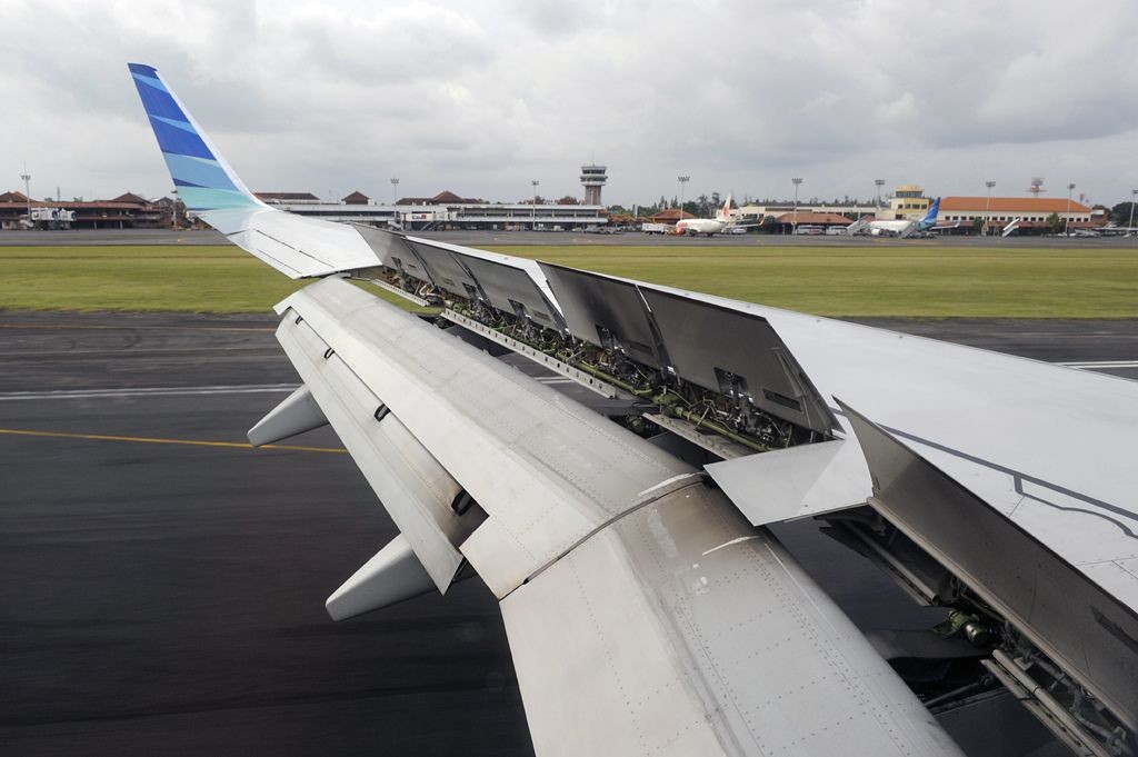 A view of spoilers of an airplane through the aircraft window. 