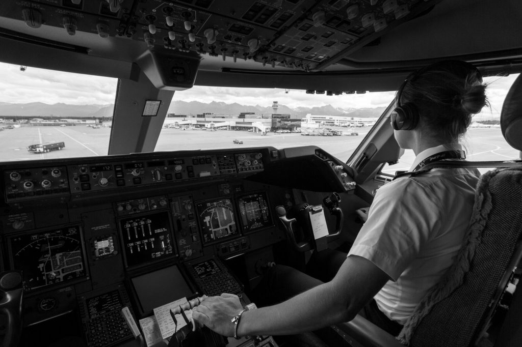 A Boeing 747 cargo pilot sitting in front of the aircraft's instrument panel.