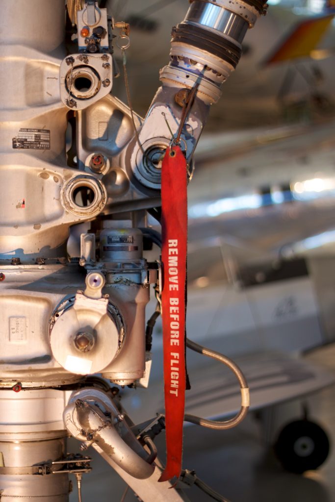 A fragment of an aircraft's landing gear with a tag "remove before flight". 