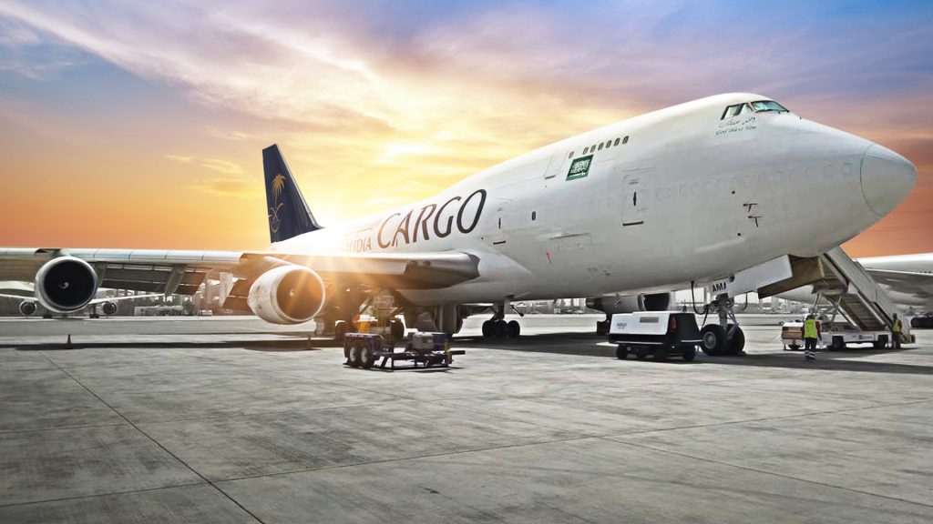 A Boeing aircraft for moving freight stationed at an airport. Image source: https://www.aircargonews.net/freighters-world/saudia-cargo-expands-fleet-with-boeing-747-400f/