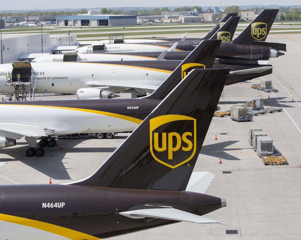 A fleet of UPS cargo aircrafts parked and unloaded at UPS Worldport at San Bernardino International airport in Southern California on a clear day.