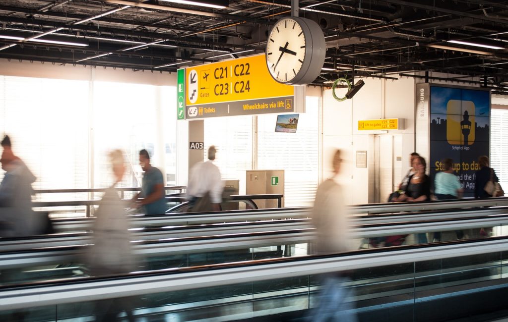 An example of a part of airport logistics: walkways for travellers and clear signs to gates above. 