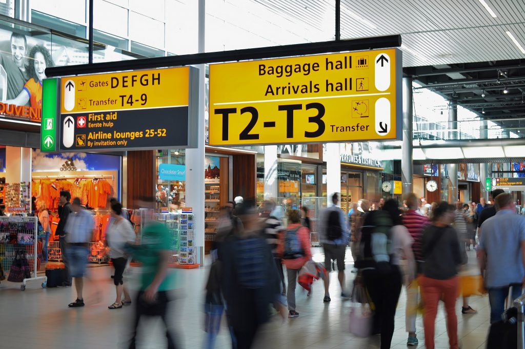 A sign pointing to gates, terminals T2 and T3, baggage and arrival halls in Amsterdam Airport Schiphol.