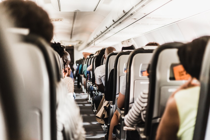 Tourists and other travellers sitting aboard a small aircraft.