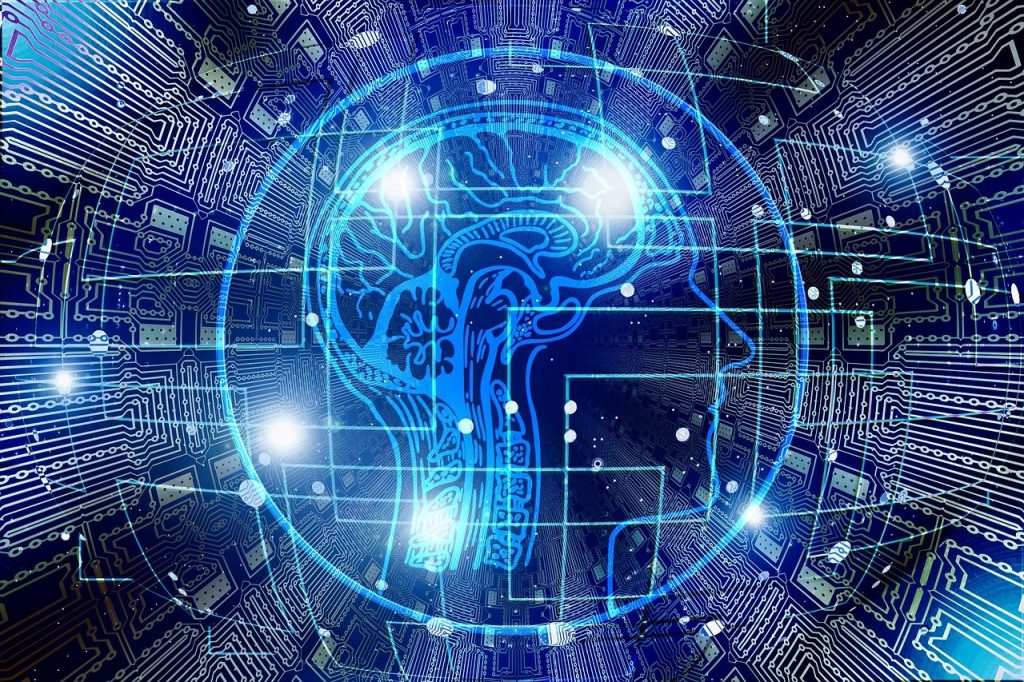 A visual representation of artificial intelligence (AI): an outline of a human head with visible brain, surrounded by electrical circuits. 