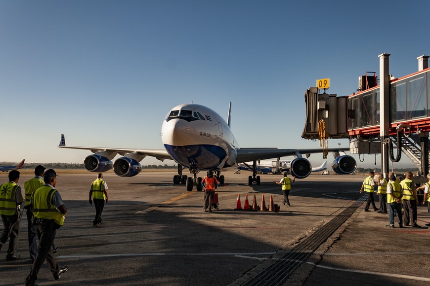 Avionics equipment mechanics and other ground staff at an airport, ready to service an aircraft before flight.