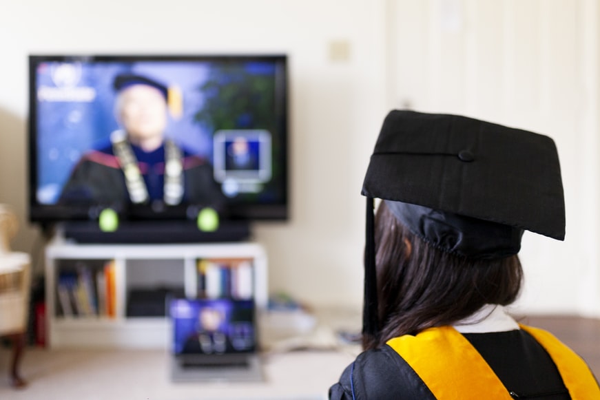 A person receiving their college degree from a remote learning program, created by a college, via a video conference.