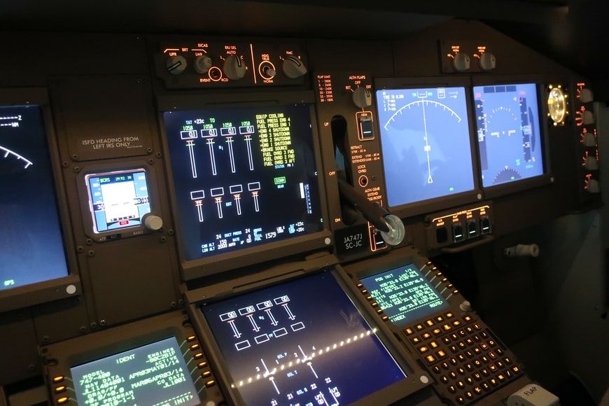 A central view of an aircraft cockpit equipment displaying various information and aviation acronyms.