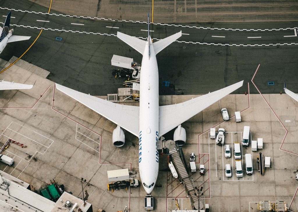 A United Airlines passenger jet being serviced before the flight by a fixed-base operator.