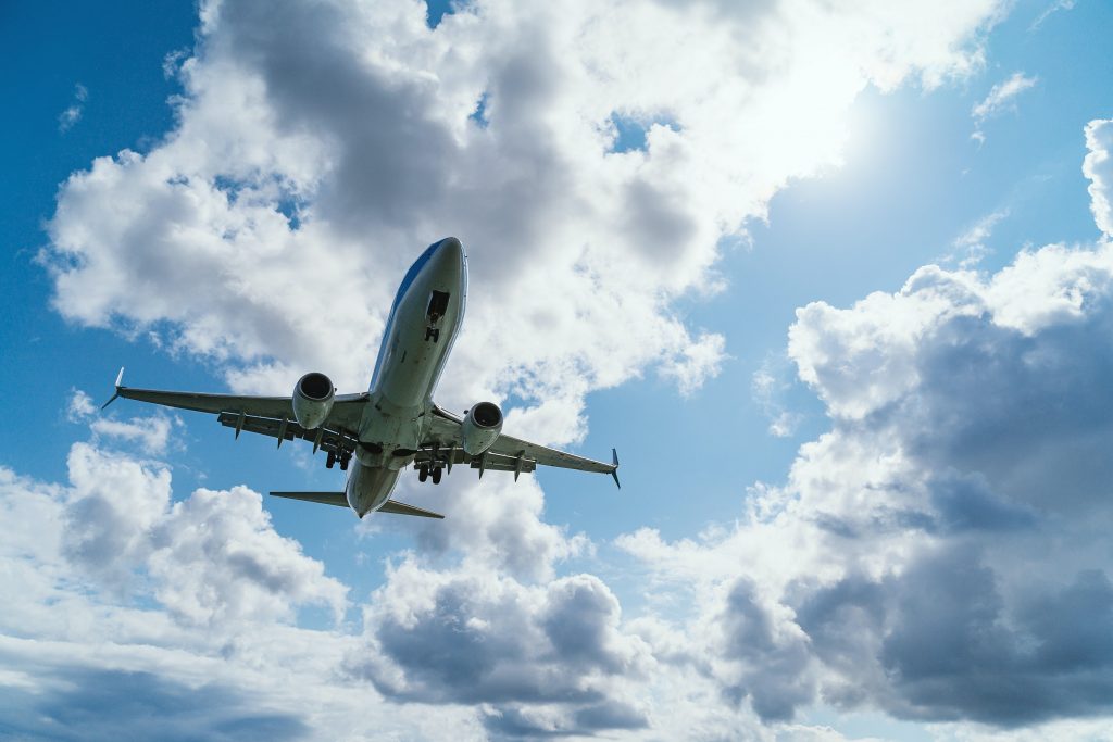 A commercial airliner flying through class A airspace on a cloudy day.