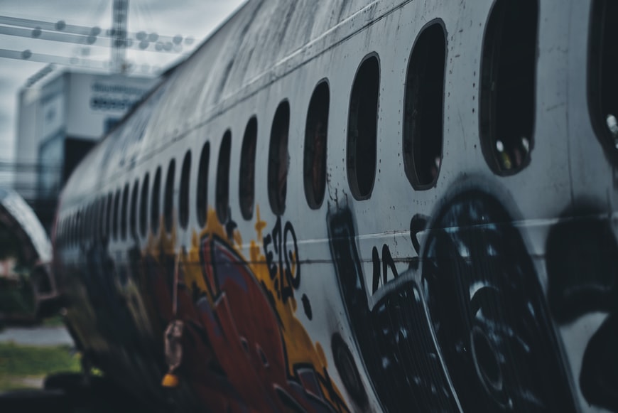 A scrapped and abandoned airplane covered in graffiti at an airplane graveyard. 