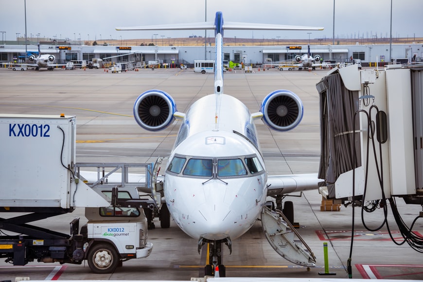 A small regional jet being serviced at Denver airport