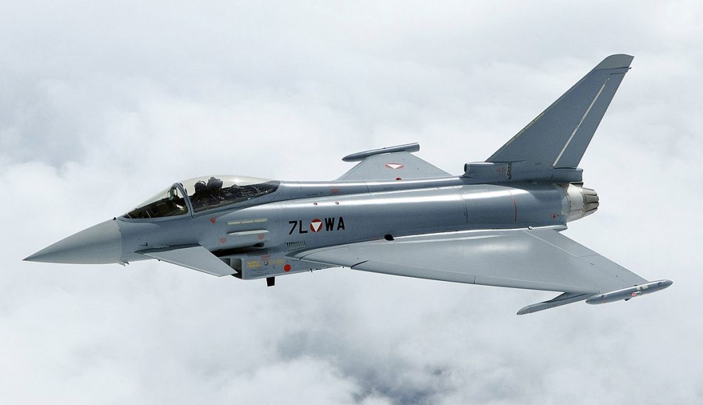 Eurofighter Typhoon with its pilot flying through grey clouds.