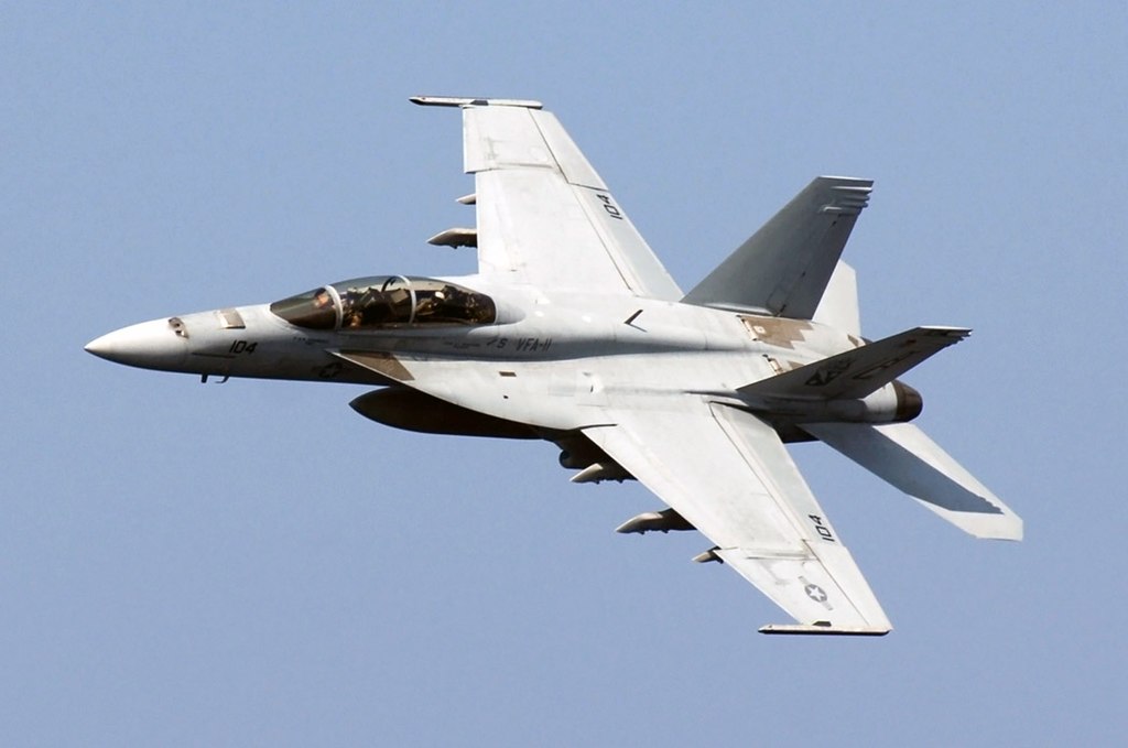 Boeing F/A-18E/F Super Hornet in flight across the sky.