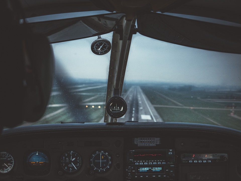 A view of a landing strip through cockpit windows.