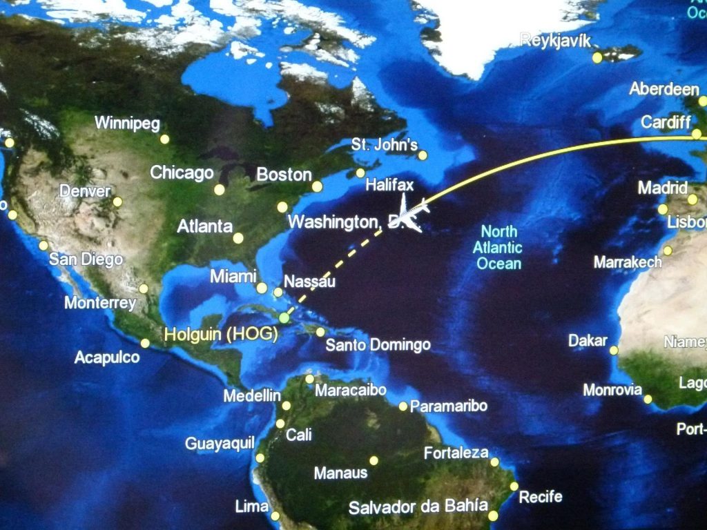 An illustration of an airplane flying down a route from the UK to Holguin.