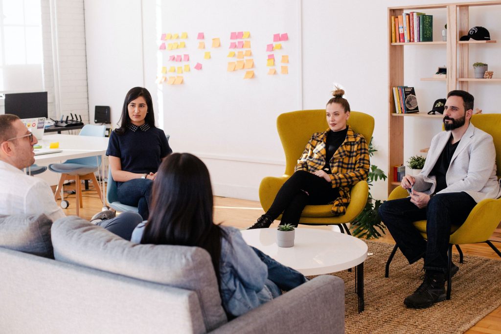 A team at work communicating on work-related topics in a bright meeting room.