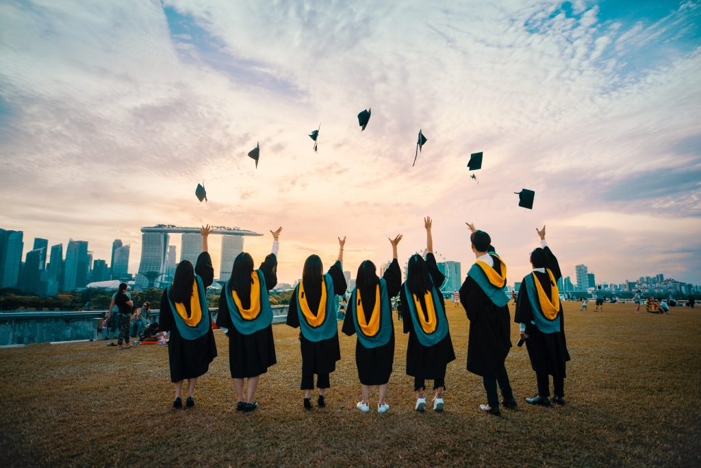 Students throwing their graduation caps in the air.