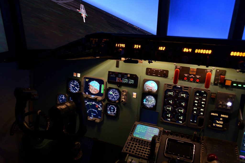A central view of a flight simulator cockpit. 