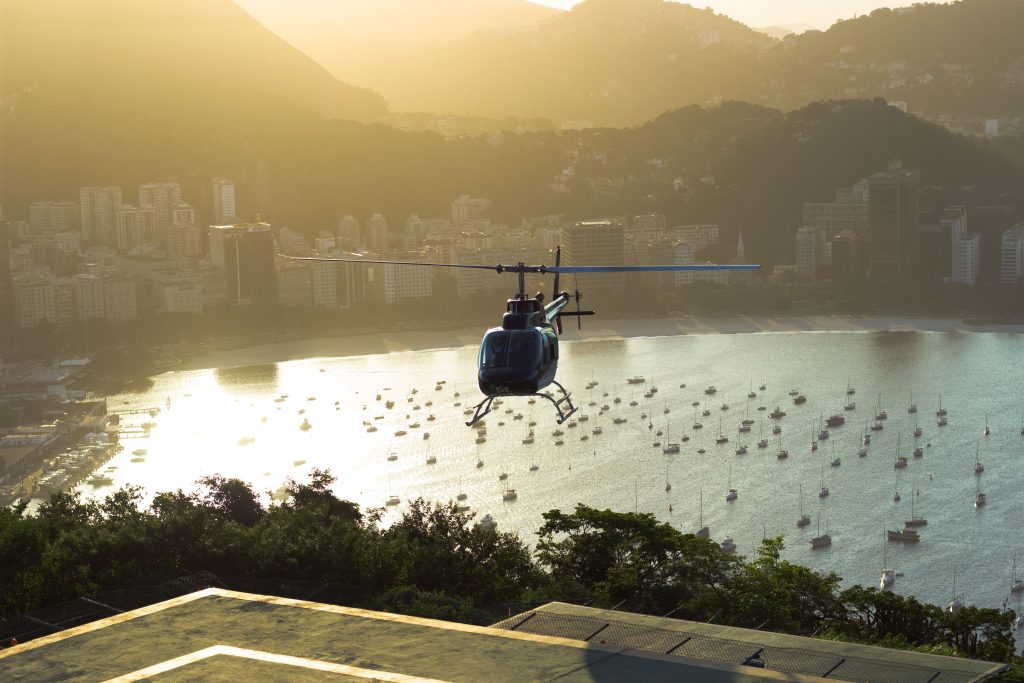 A helicopter flying over a bay in Brazil. 