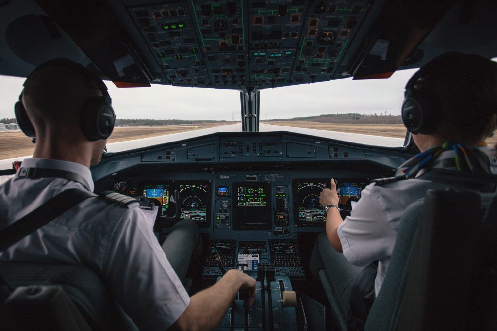 Two airline pilots in a cockpit, ready for take off. 