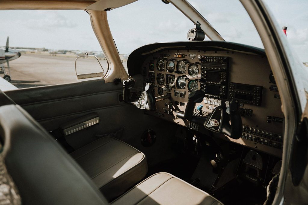 The interior of a single engine aircraft cockpit. 