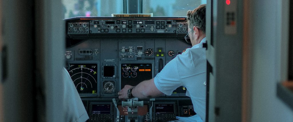 A pilot in command and first officer sitting in an aircraft cockpit.