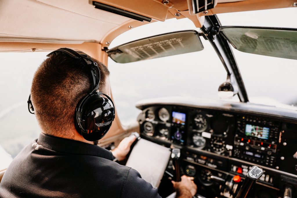 A private pilot controlling a small plane on a cloudy day.