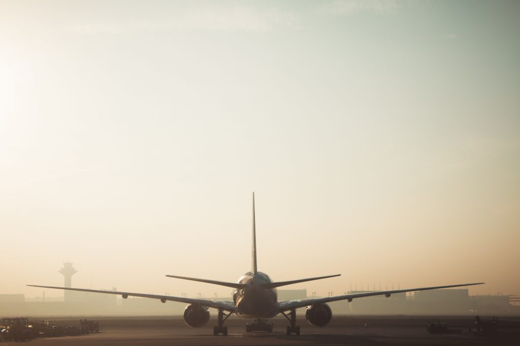 An aircraft ready for takeoff on a foggy morning. 