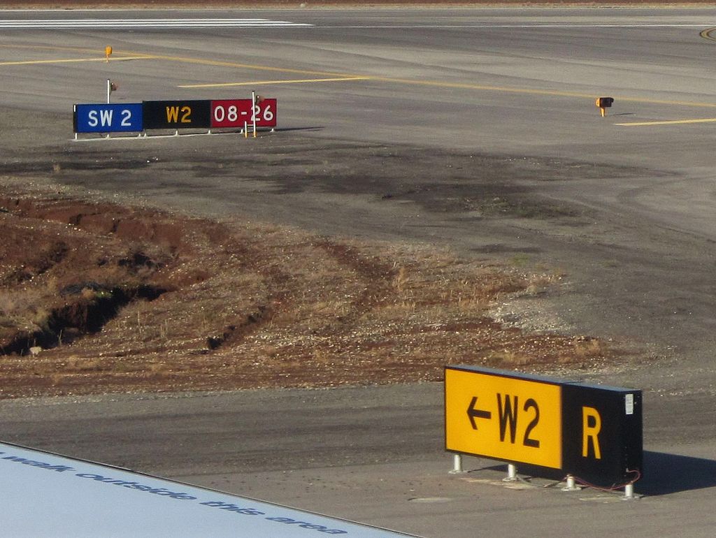 Taxiway signs during daytime.