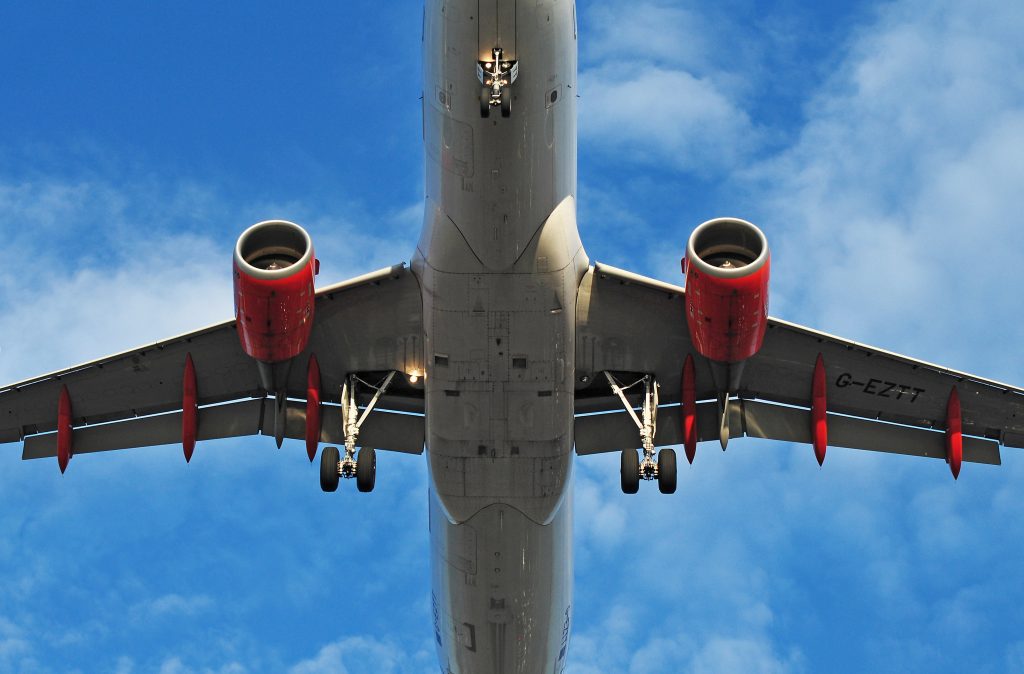 A view of an airplane in flight from below.