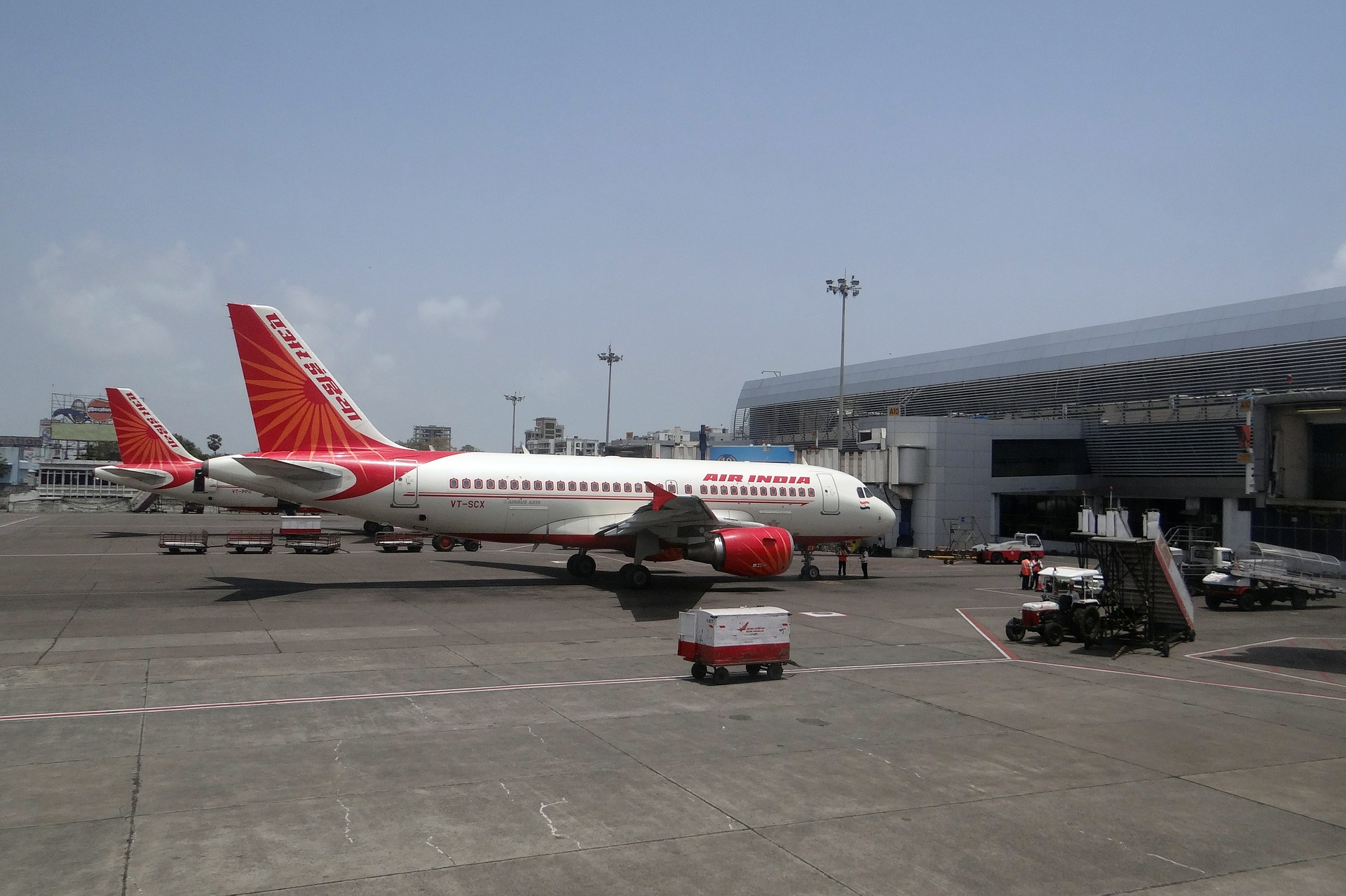 Two Air India's, India's aviation history's first commercial airline's aircraft stationed at an airport.