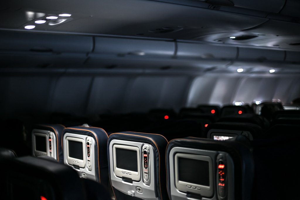 A dark aircraft cabin on a red eye flight. 