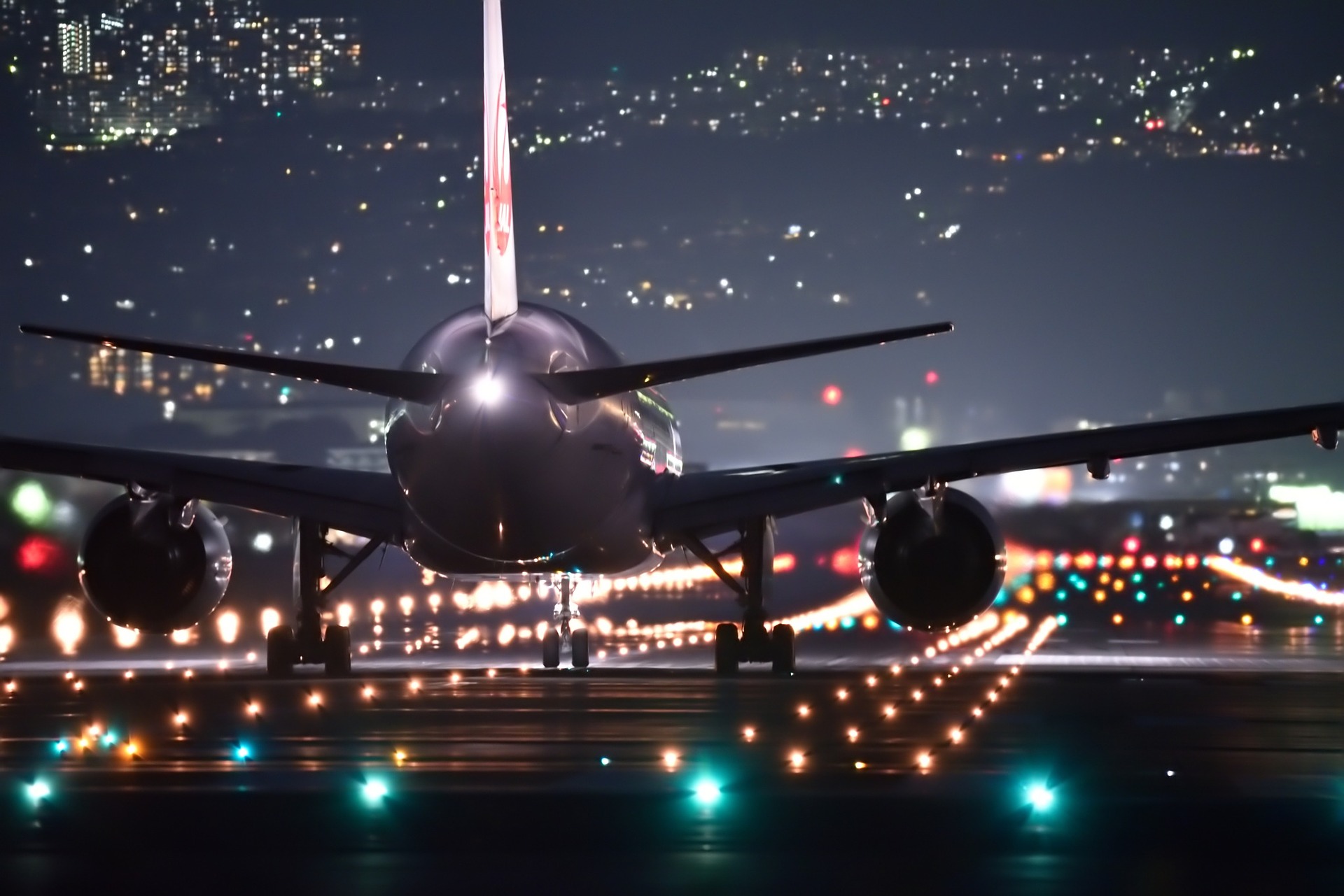 An airplane ready to take of from the runway at night.