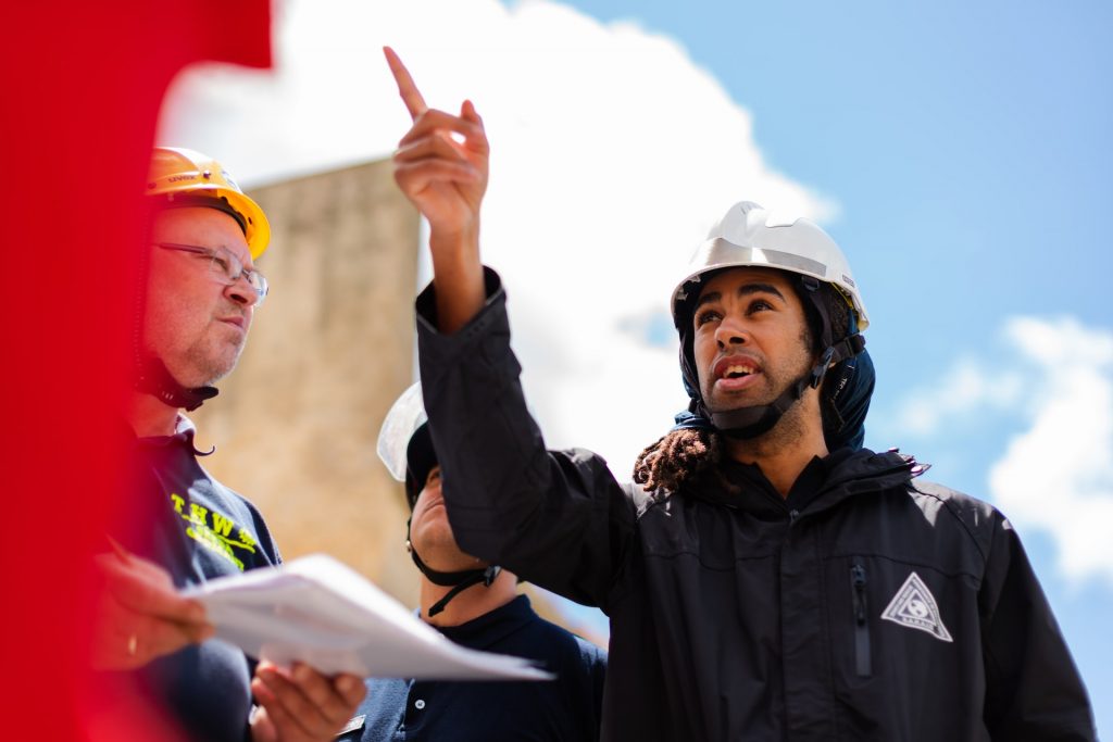 A team of engineers discussing and pointing. 