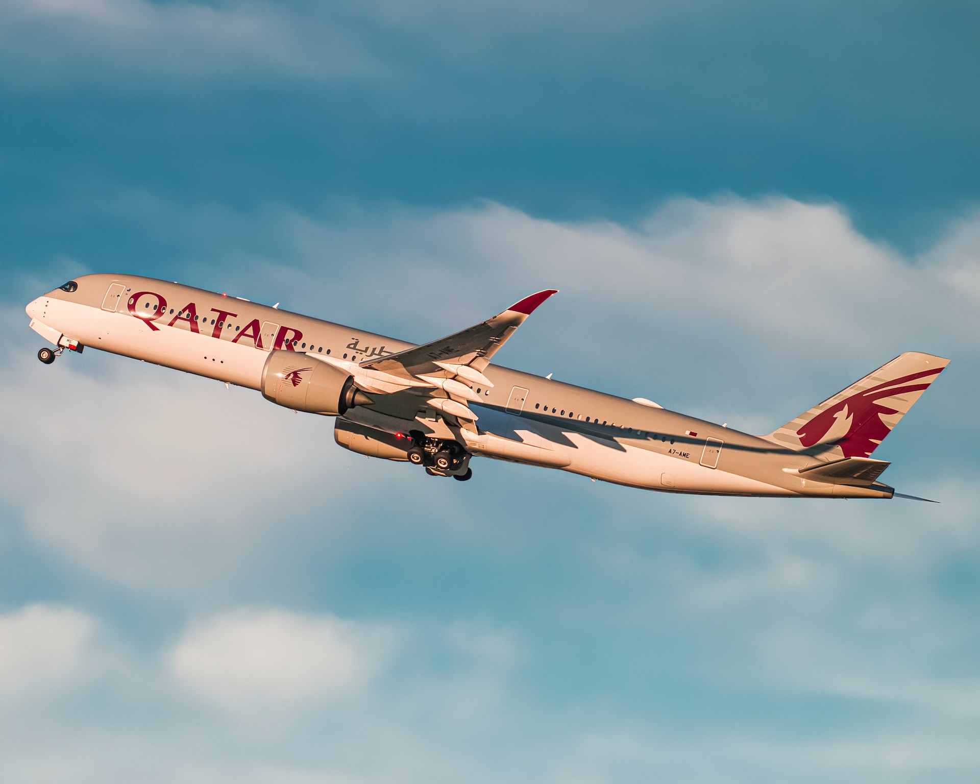 Qatar Airways airplane lively with airline branding: oryx on the tail and engines of an aircraft.