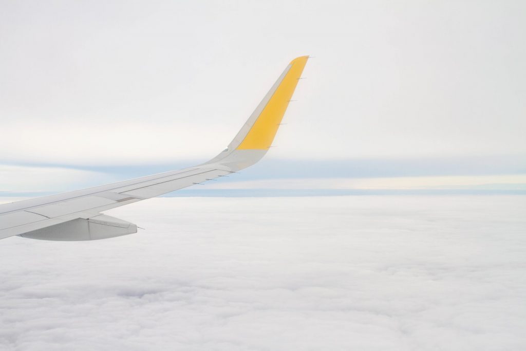 An aircraft flying high above clouds below the service ceiling.