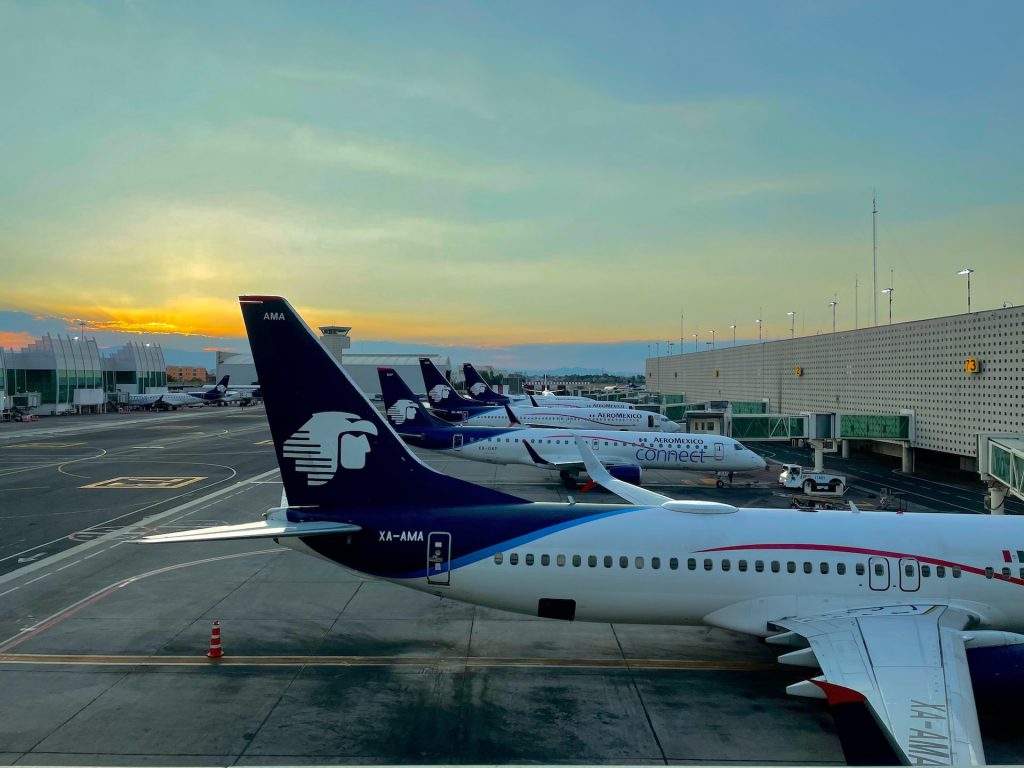 One of the most profitable airlines Aeromexico aircraft stationed at an airport in the morning.