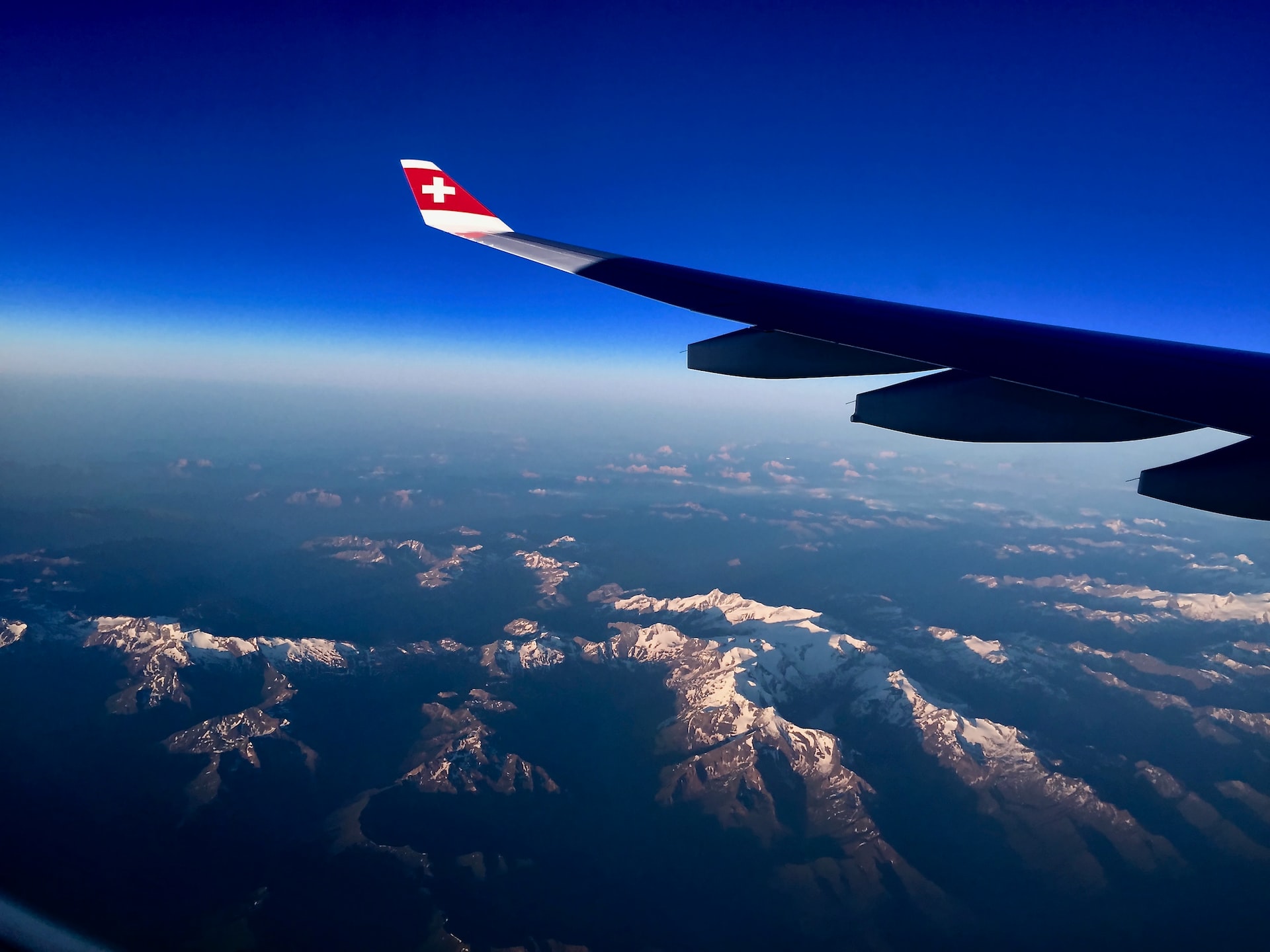 An aircraft flying high over mountains under the service ceiling.