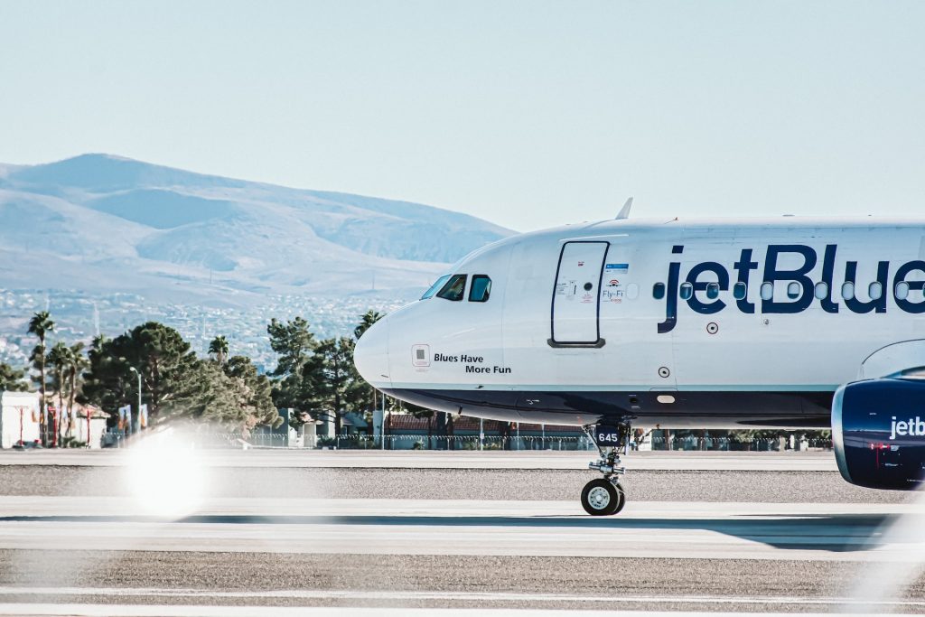 jetBlue aircraft with a tagline on the side: Blues have more fun.