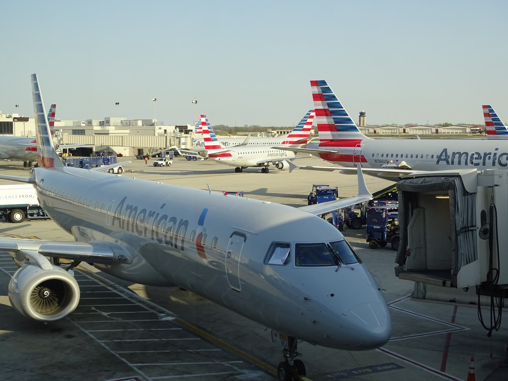 Low environmental impact American Airlines aircraft stationed at jetways at an airport. 