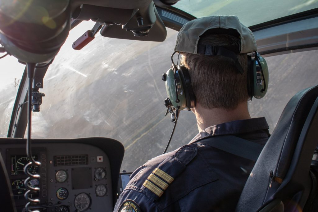 A pilot controlling a plane and communicating with ATC on radio.