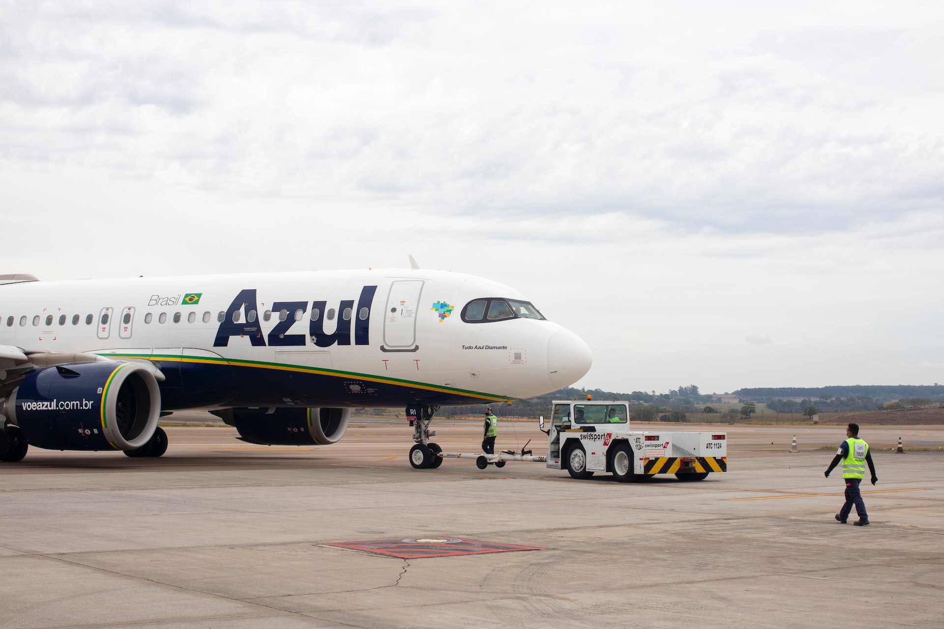 An airplane being tugged by a tug vehicle.