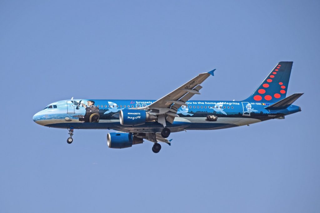 A brussels airlines plane with a name Maigritte.