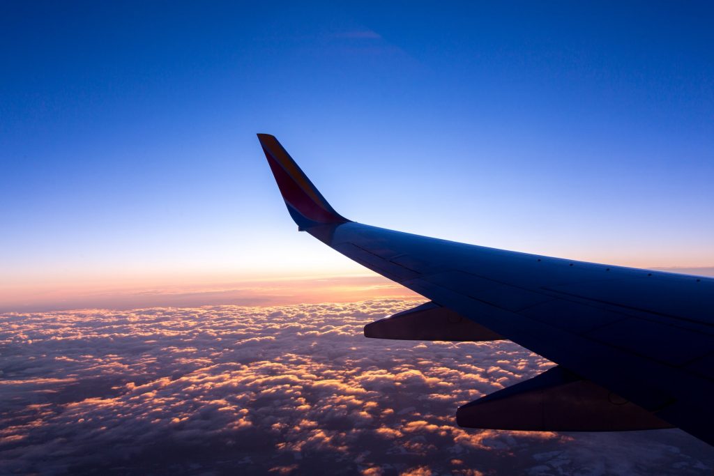 An aircraft flying high above clouds.