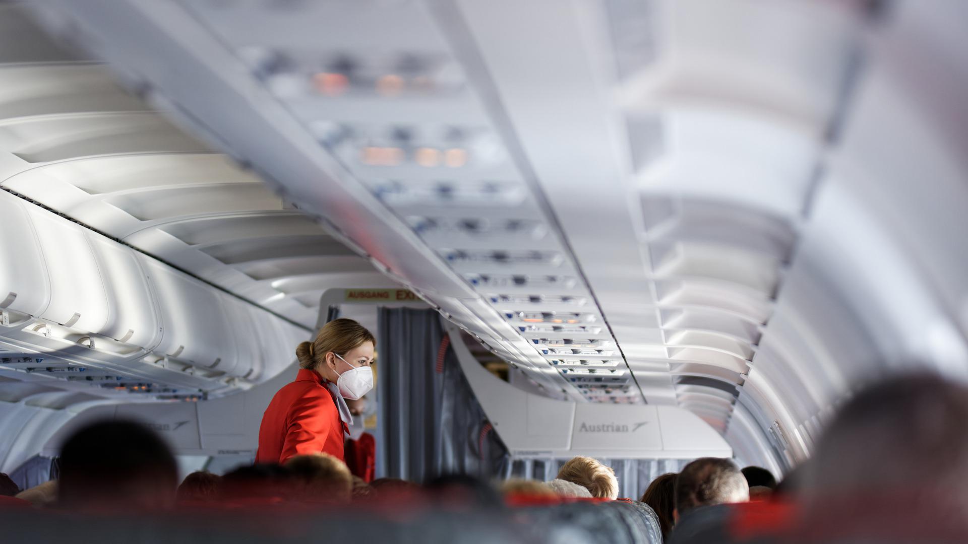 Flight attendants servicing passengers onboard.