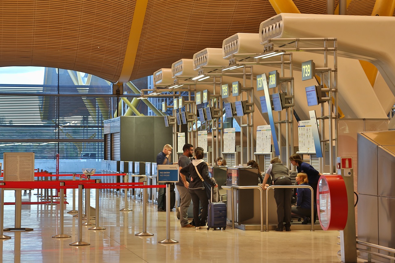 Gate agent working at a check in desk in an airport.