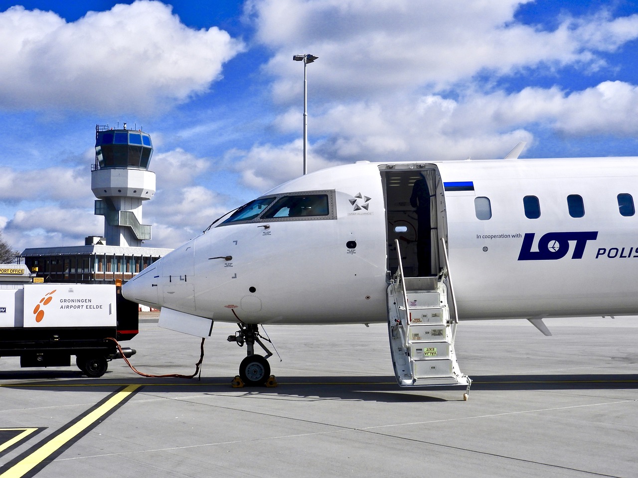 An aircraft recharging before flight on a summer day.