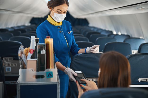 A flight attendant servicing a passenger.