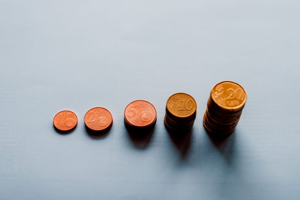 Euro coins stacked up in piles.